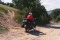 Motorbiker back view, in action, summer day, motorcycle off road, the driver with adventure, touring motorbike with side bags,