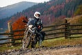 Motorbiker travelling in autumn mountains