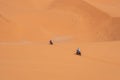 Motorbikers driving off-road in the Erg Chebbi desert near Merzouga Royalty Free Stock Photo