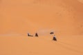 Motorbikers driving off-road in the Erg Chebbi desert near Merzouga Royalty Free Stock Photo