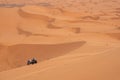 Motorbikers driving off-road in the Erg Chebbi desert near Merzouga Royalty Free Stock Photo