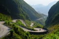 Motorbikers on winding roads through valleys and karst mountain scenery in the North Vietnamese region of Ha Giang / Van