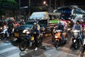 Motorbikes at a crossroads at night in Thailand