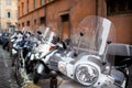 Motorbikes and scooters parked in one of the ancient streets