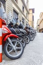 Motorbikes standing in the street in Florence