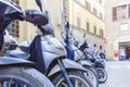 Motorbikes standing in the street in Florence