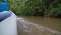 motorboat going down tropcial river in the amazon jungle