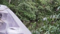 motorboat going down tropcial river in the amazon jungle