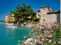 Motorboat just passing under the bridge that leads to Scaligero Castle in the village of Sirmione