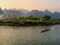 Motorboat moving on Nam Song River at susnet in Vang Vieng, Vientiane Province, Laos Royalty Free Stock Photo