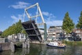 Motorboat passing opened bridge in Dutch medieval city Weesp Royalty Free Stock Photo