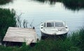 Motorboat At The Pier Among The reeds In A River Bay Royalty Free Stock Photo