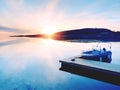 Motorboat for sport fishing tied to a wooden floating dock. Fishing boat in bay port, Royalty Free Stock Photo