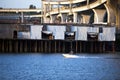 Motorboat on the Willamette River with old docks concrete overpass Royalty Free Stock Photo