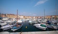 Motorboats and boats on water in port of Rovinj, Croatia. Yachts landing, vintage houses of old town on the background Royalty Free Stock Photo