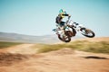 Motorcross, air jump and offroad sports with motion blur, speed challenge or desert. Driver, cycling and stunt on dirt