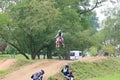 A motor bike flying at the motorcross race track.