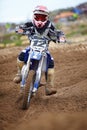 Motorcross, dirt road and athlete riding bike with speed for a race or sports competition. Challenge, fitness and man Royalty Free Stock Photo