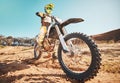 Motorcross, motorcyclist and man in sports gear for challenge, offroad race and desert rally. Driver, bike and ready for Royalty Free Stock Photo