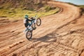 Motorcycle athlete, dirtbike and motion blur for sports on sand trail for freedom. Driver, cycling and offroad