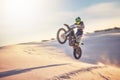 Motorcycle, athlete and sports outdoor with jump stunt, fitness in desert and extreme sport with speed and freedom