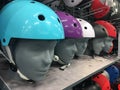 Motorcycle Colorful helmet Shop on the shelves. Multi-colored protective bike helmets in the shop. A mannequin wearing a Royalty Free Stock Photo