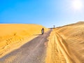 Motorcycle crossing an arid dune terrain