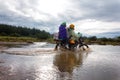 Motorcycle crossing flooded bridge