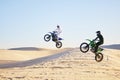 Motorcycle, desert and jump in air, speed and competition at outdoor race for performance, goal or off road. Motorbike Royalty Free Stock Photo