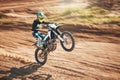 Motorcycle, dirt track stunt and air jump in desert, sand trail and freedom. Driver, cycling and offroad freedom, sports