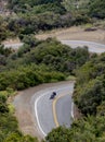 Motorcycle driver takes a curve in Mulholland highway in Southern California.