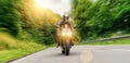 Motorcycle driving on empty road at sunset. adventure freedom of single driver motorbike on highway. copy space for individual Royalty Free Stock Photo