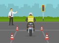 Motorcycle driving practice test with red cones. Llearner motorcyclist practising to ride a bike. Instructor makes a stop gesture.