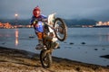 Motorcycle Enduro riding wheelies on the beach