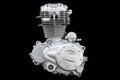 Motorcycle engine isolated on black background. Air cooled internal combustion engine for motorcycle, snowmobile or ATV.  Silver Royalty Free Stock Photo