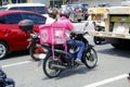 Motorcycle food delivery driver carry customer orders during the Covid 19 virus outbreak