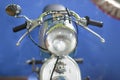 Motorcycle front detail with headlight, handlebars, mirrors, old vintage Royalty Free Stock Photo