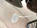 Motorcycle front foot gear position at frame on cement flooring closeup.