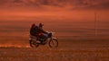On a motorcycle in the Gobi desert. Dust from under the wheels. Wild Mongolian road. 06.09.2019. Gobi Desert, Mongolia
