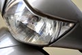 Motorcycle headlight close-up, front view, detail, focusing on headlight, selective focus, zoomed photo. Royalty Free Stock Photo