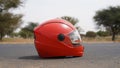 Motorcycle helmet on a countryside street road. Helmet with red polish