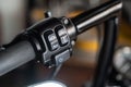 Motorcycle high headlight switch ,button Horn switches and turn signals on a motorcycle handlebar in garage,maintenance, repair Royalty Free Stock Photo