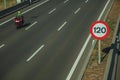 Motorcycle on highway and SPEED LIMIT signpost in Madrid