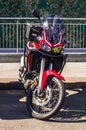 Motorcycle Honda CRF1100L with dual-clutch transmission ion the city parking. Front view of motorbike parked on city road