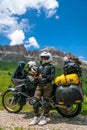 Motorcycle lady standing with adventure motorbike on the top mountain, enduro, off road, beautiful view, danger road in mountains Royalty Free Stock Photo