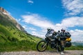 Motorcycle lady standing with adventure motorbike on the top mountain, enduro, off road, beautiful view, danger road in mountains Royalty Free Stock Photo