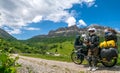 Motorcycle lady standing with adventure motorbike on the top mountain, enduro, off road, beautiful view, danger road in mountains Royalty Free Stock Photo