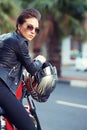 Motorcycle, leather and helmet with woman in city for travel, transport or road trip as rebel. Fashion, street and Royalty Free Stock Photo