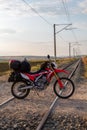 Motorcycle loaded on the bag, on train tracks