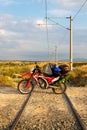 Motorcycle loaded on the bag, on train tracks